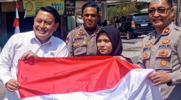 Camat Rancaekek membagikan Bendera merah putih kepada pengendara sepeda motor Tanamkan Edukasi Perjuangan HUT RI ke-81